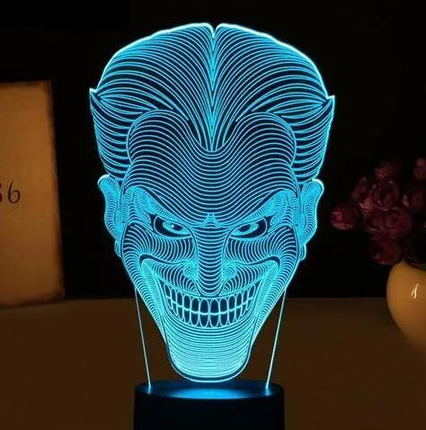 3D acrylic LED table lamp with USB cable and remote control on a desk