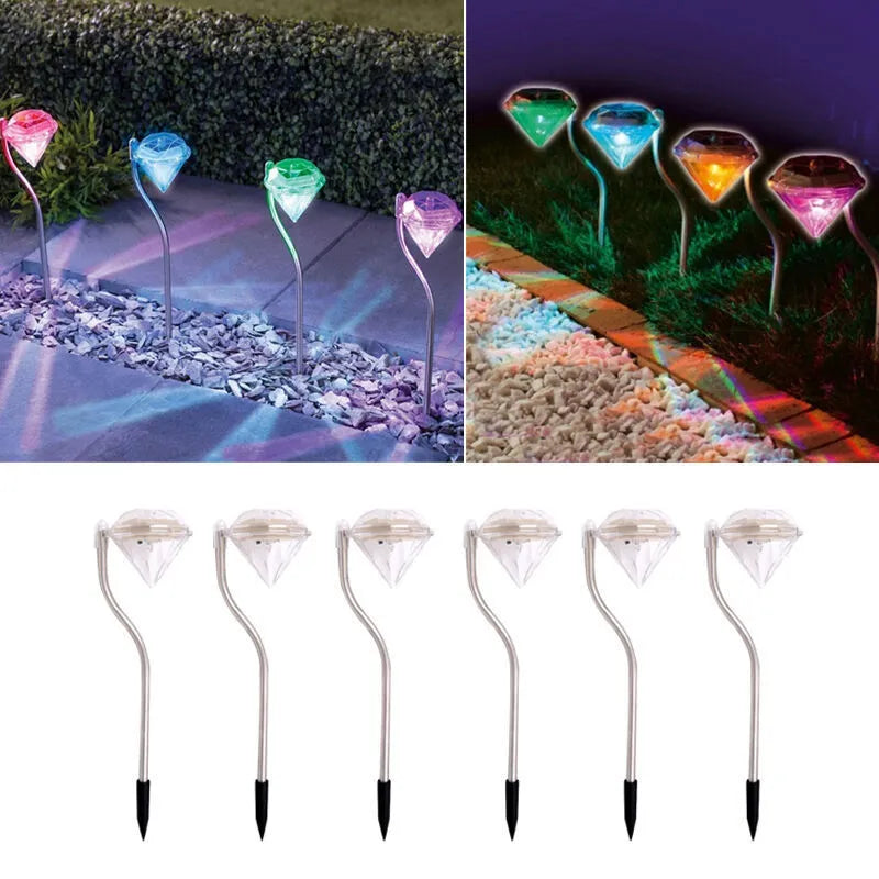 White solar-powered LED garden spotlight with adjustable head on a stake for outdoor use.