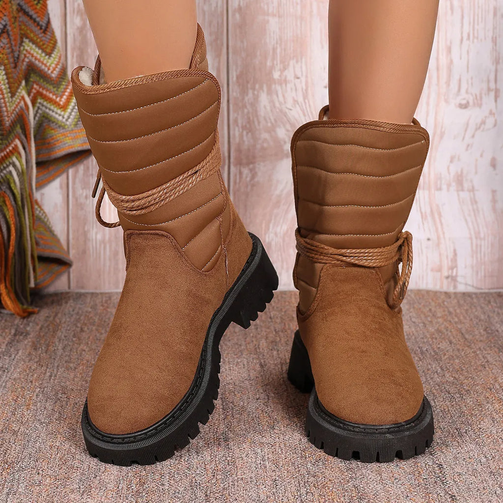 Women's black suede chunky heel snow boots with fleece lining and lace-up design.