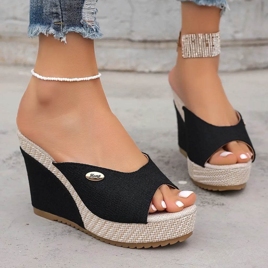 Women's black wedge sandals with buckle details, first layer cowhide upper, leather lining, and cloth sole on white background
