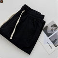 Men's loose straight-leg casual summer pants in beige with a drawstring waistband.