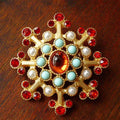 A diamond-shaped Retro Court Baroque vintage brooch made from zinc alloy, showing ornate detailing.