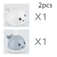 Automatic spray whale bath toy with LED lights floating in water