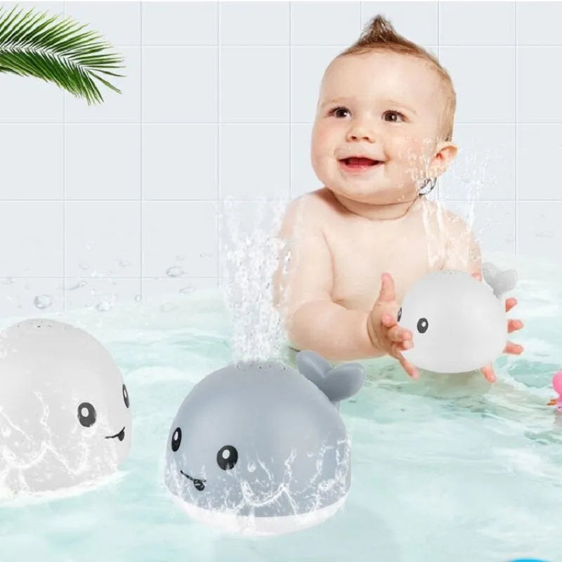 Automatic spray whale bath toy with LED lights floating in water