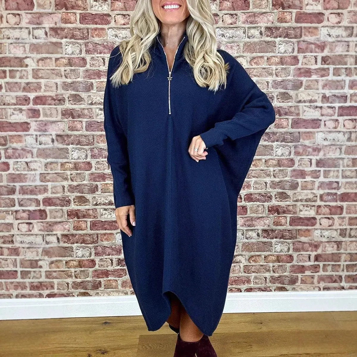 Women's solid colour loose fit knitted dress with raglan sleeves and a zip detail.