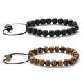 Matte black agate bead couple bracelets with a geometric design on a white background.