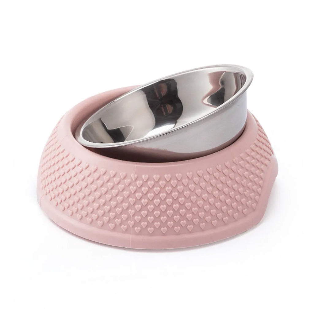 Set of four coloured stainless steel pet bowls with non-slip bases on a floor.