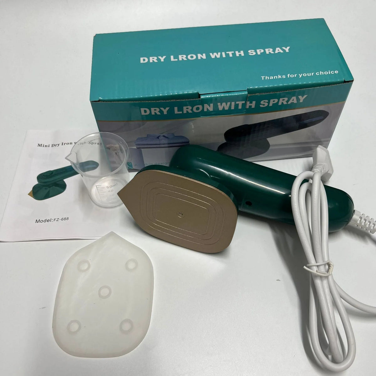 Dark green handheld garment ironing machine with titanium panel and mini steam design for travel and home use.