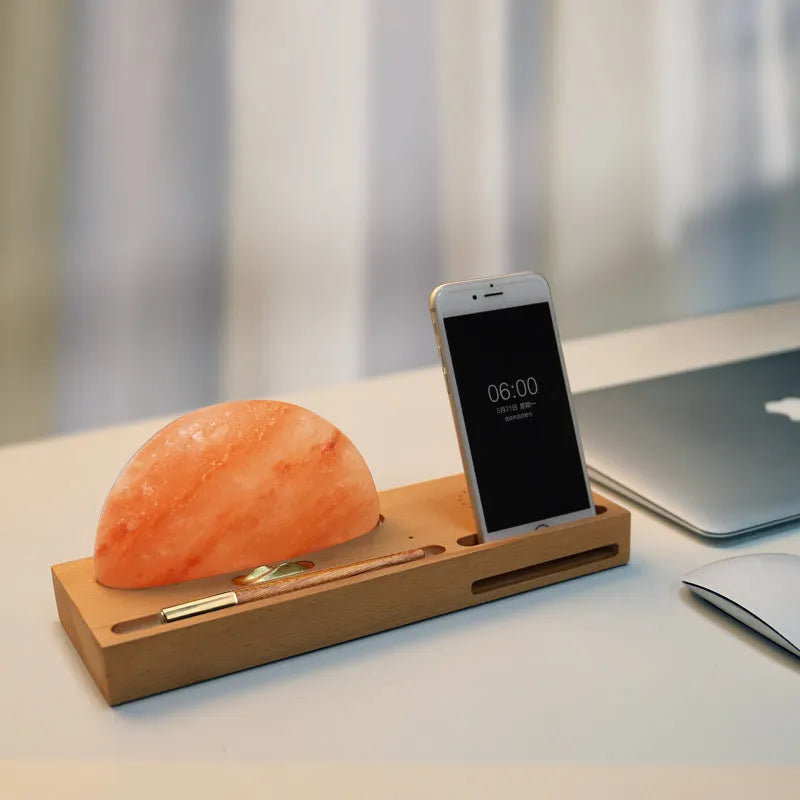 Natural crystal salt lamp with beech wood base featuring integrated wireless phone charging.
