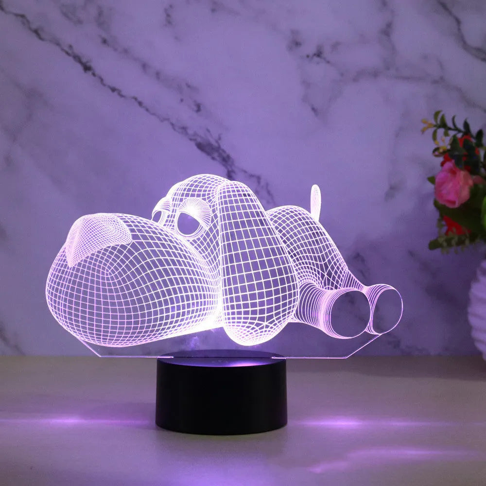 3D illusion dog lamp glowing in multiple colours on a desk with USB cable