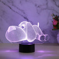 3D illusion dog lamp glowing in multiple colours on a desk with USB cable