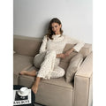 Women's white floral print bell sleeve top and matching wide leg trousers suit set