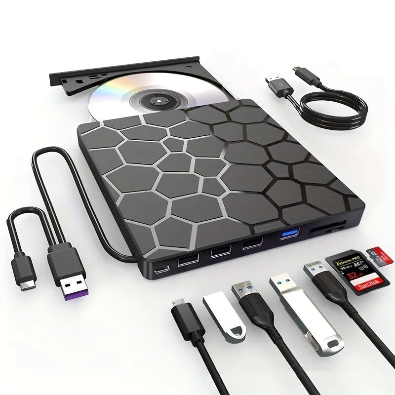 Black aluminium external USB CD drive and writer on a desk next to a laptop.