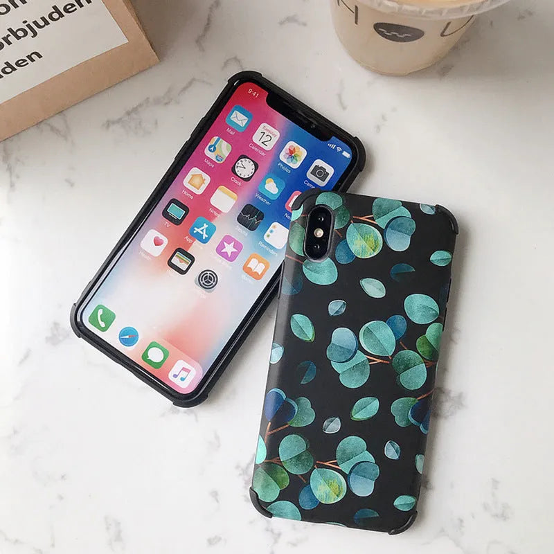 Black silicone iPhone case featuring a printed leaf design, shown fitted to a phone.