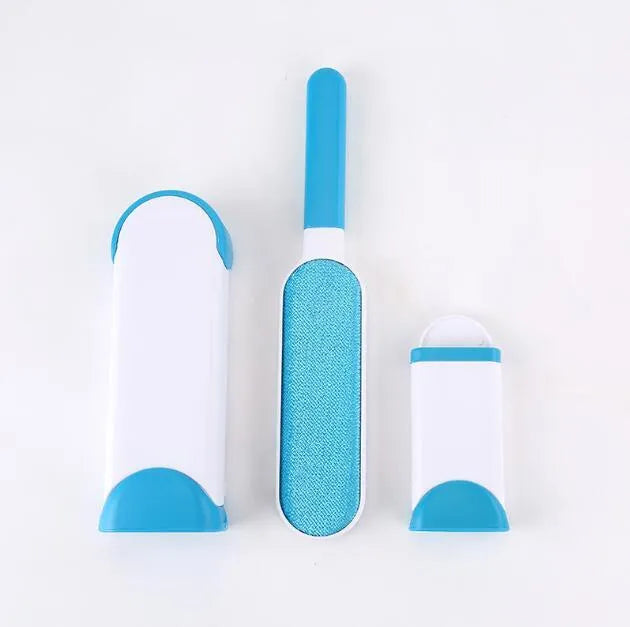 Blue reusable pet hair removal brush with self-cleaning base on a grey sofa.