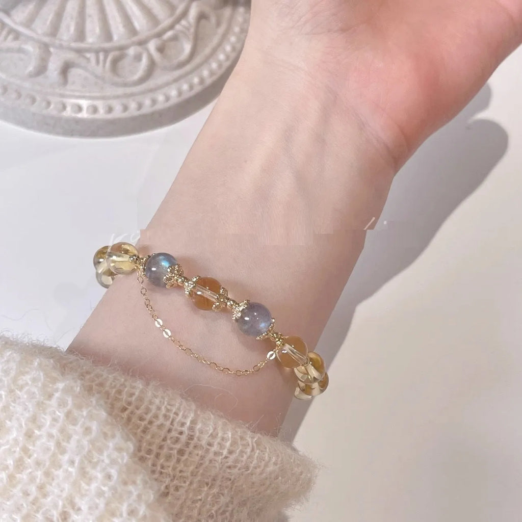 Gold electroplated women's crystal bracelet with diamond shape and fortune charm.