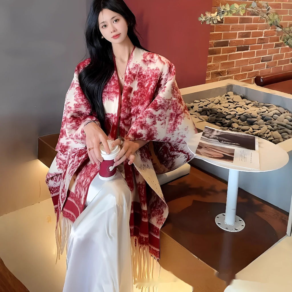 Women's tassel-trimmed scarf cape in polyester fabric shown as shawl-style accessory