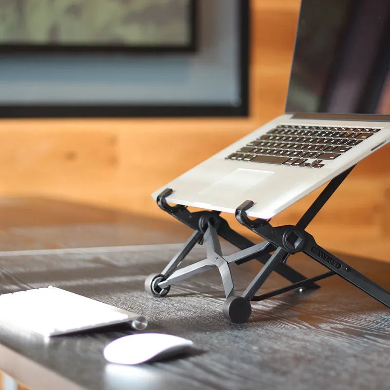 Black folding portable laptop stand showing reinforced nylon construction and compact folded dimensions