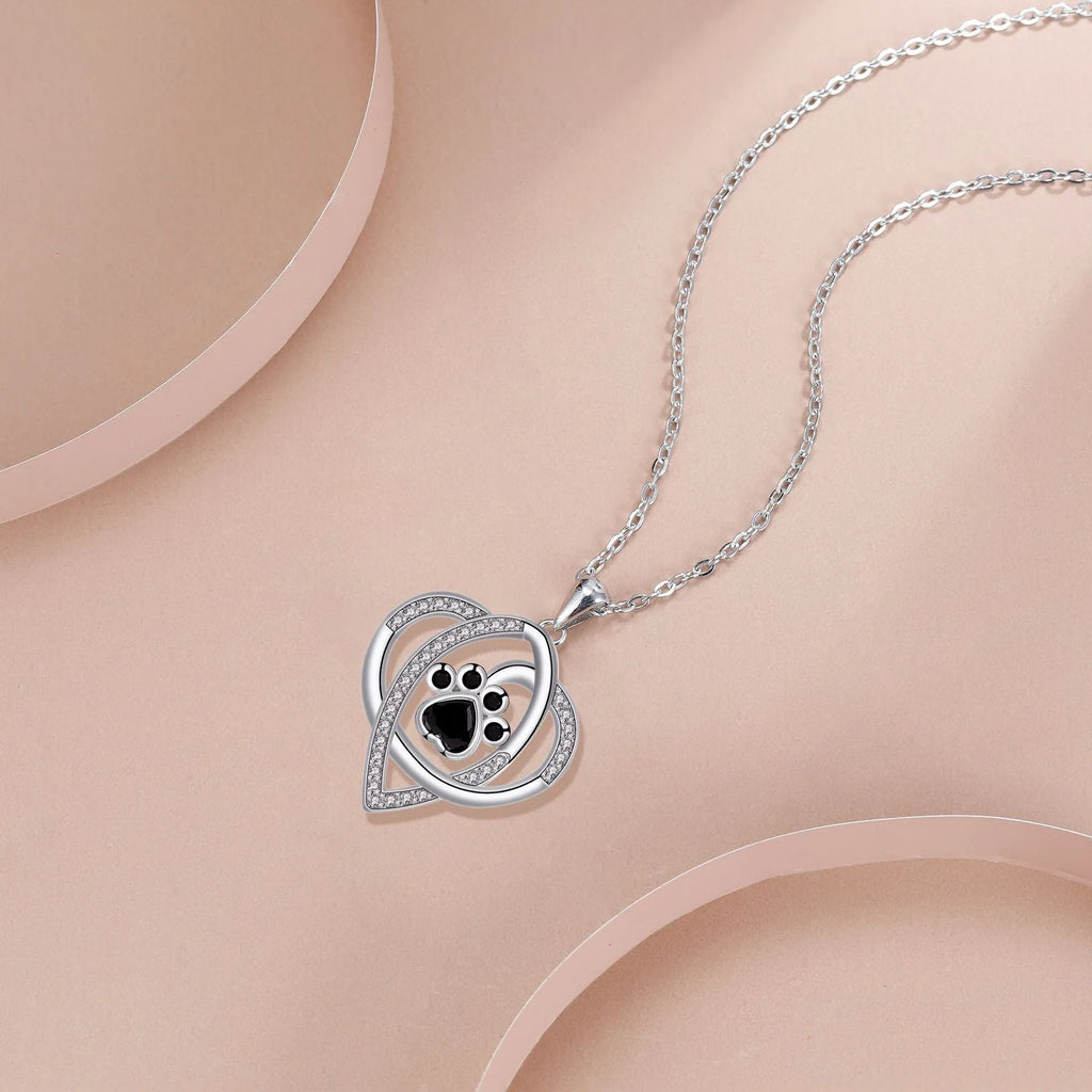 Copper necklace with cat and dog paw prints pendant on a cross chain, electroplated finish.