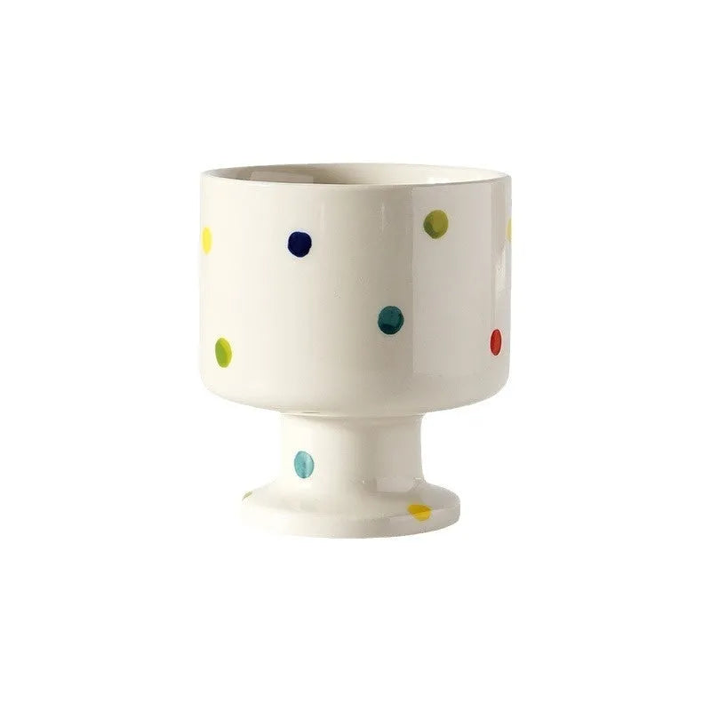 Hand-pinched irregular shaped solid colour ceramic mug on a table, showing its unique form and modern simplicity design.