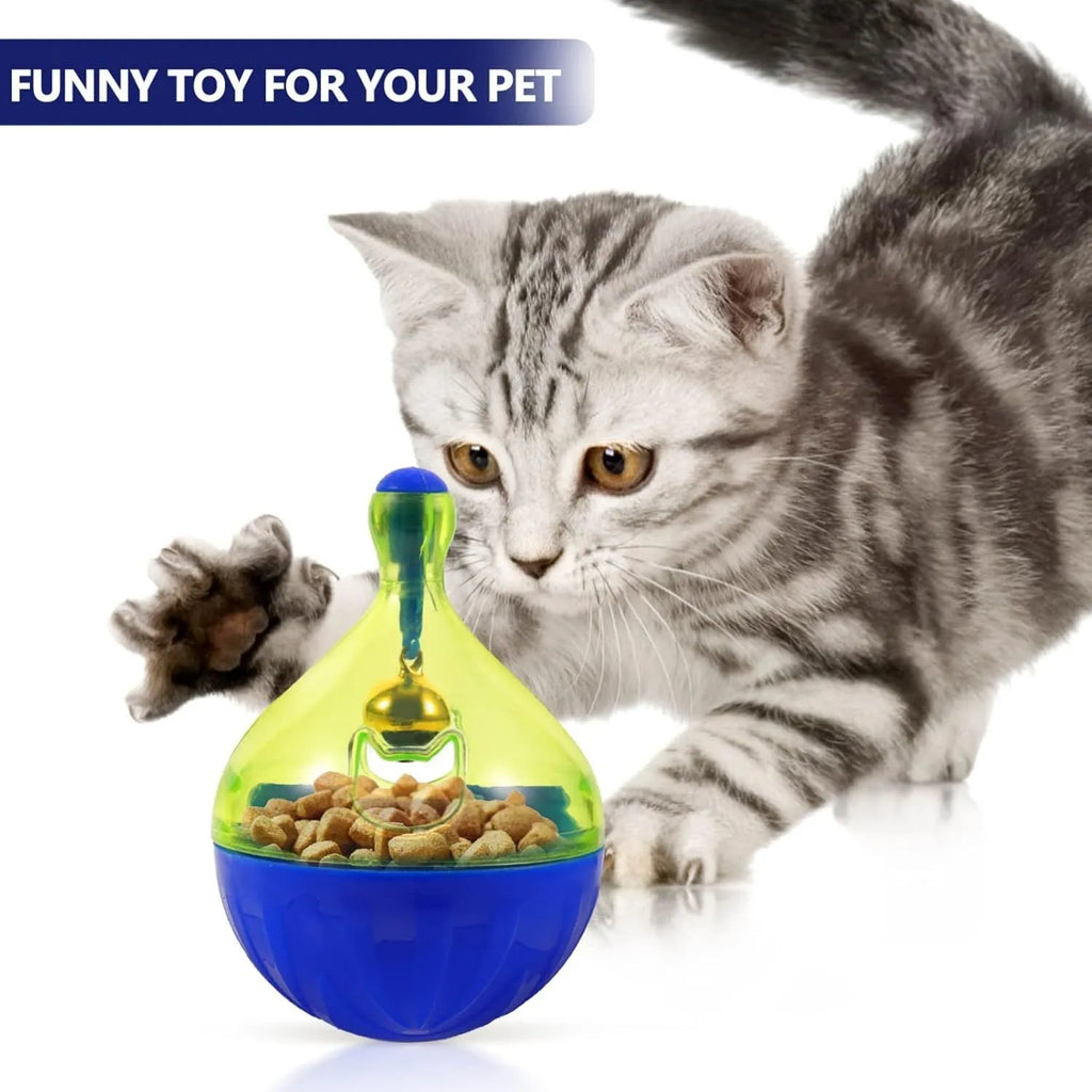 Grey tumbler-shaped interactive pet treat dispenser ball on a wooden floor.