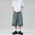 Men's loose straight-leg cropped denim shorts in light blue on a mannequin.