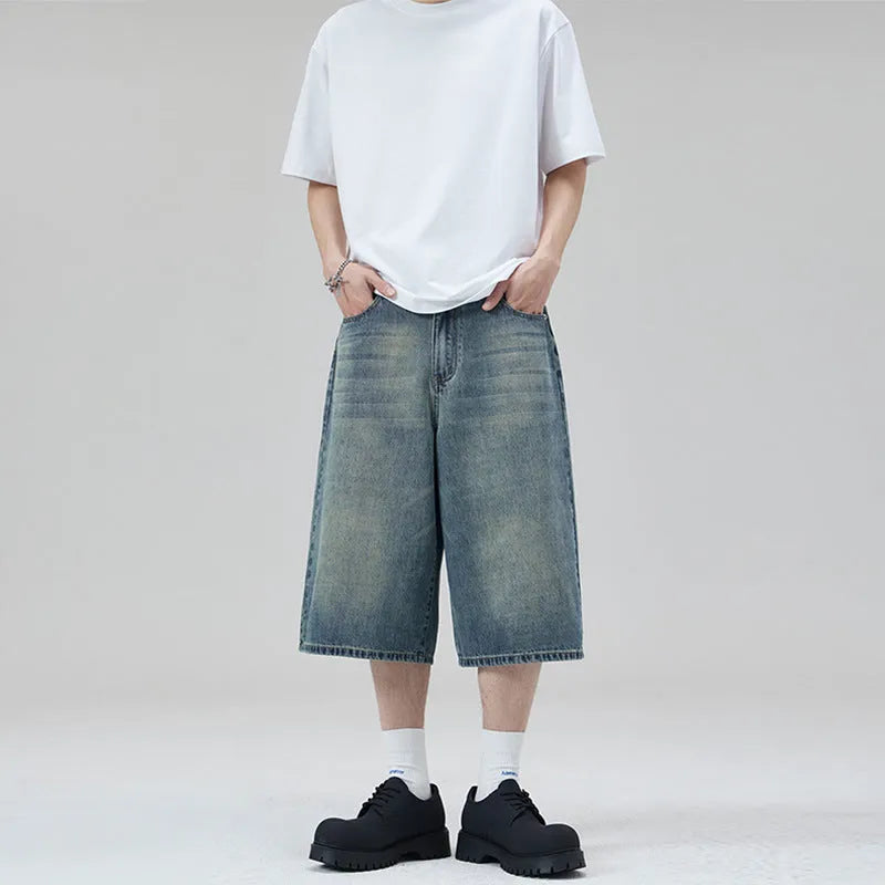Men's loose straight-leg cropped denim shorts in light blue on a mannequin.