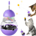 Green and purple interactive cat wand toy with a ribbon, ball, and slow feeder bowl on a stable rocking base.