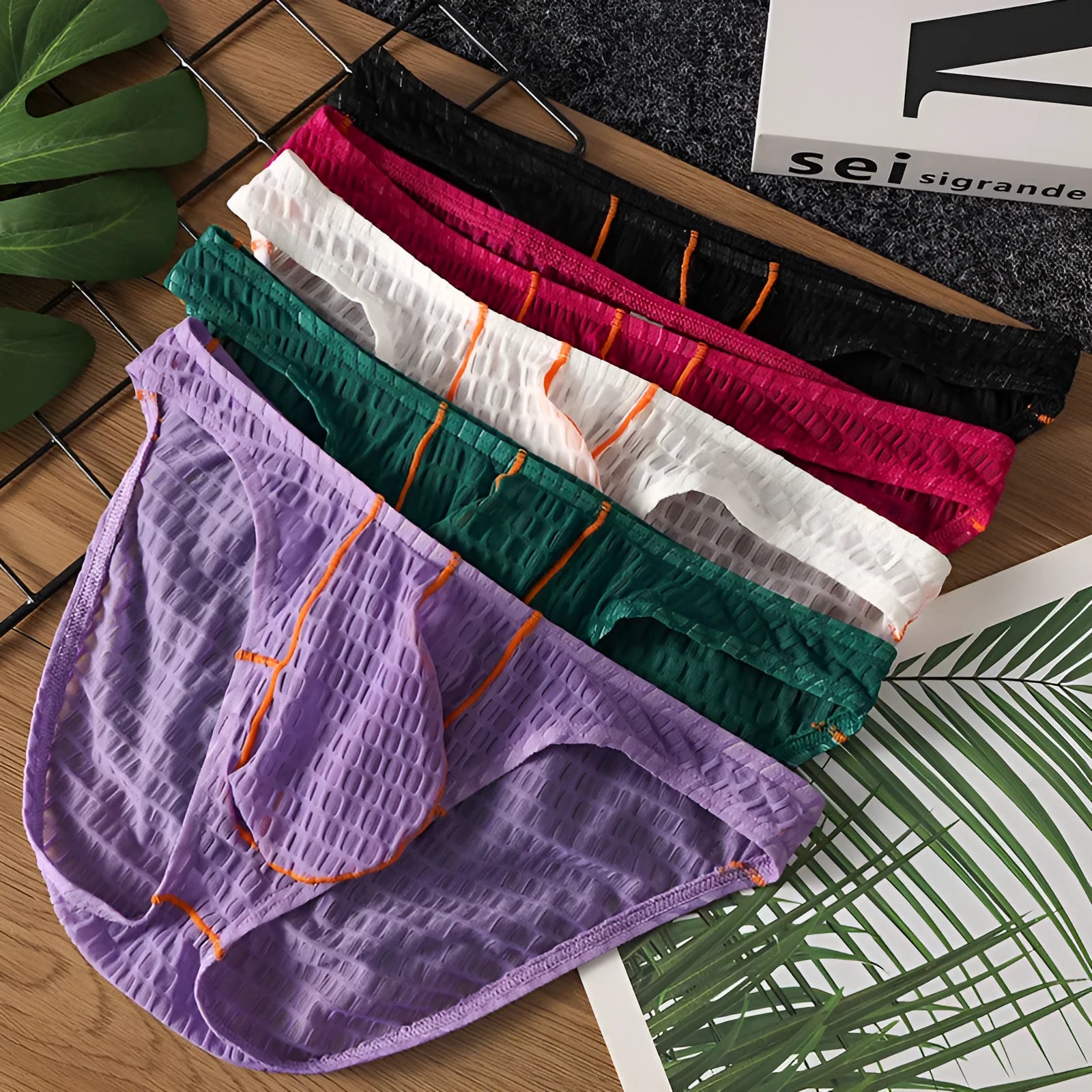 Men's solid colour low waist lace briefs on a white background.
