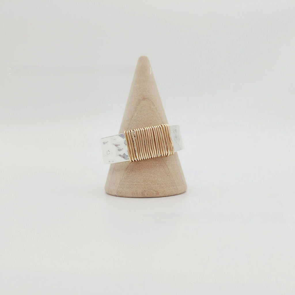 Geometric wide face copper bracelet ring with irregular coil design in silver gold finish.