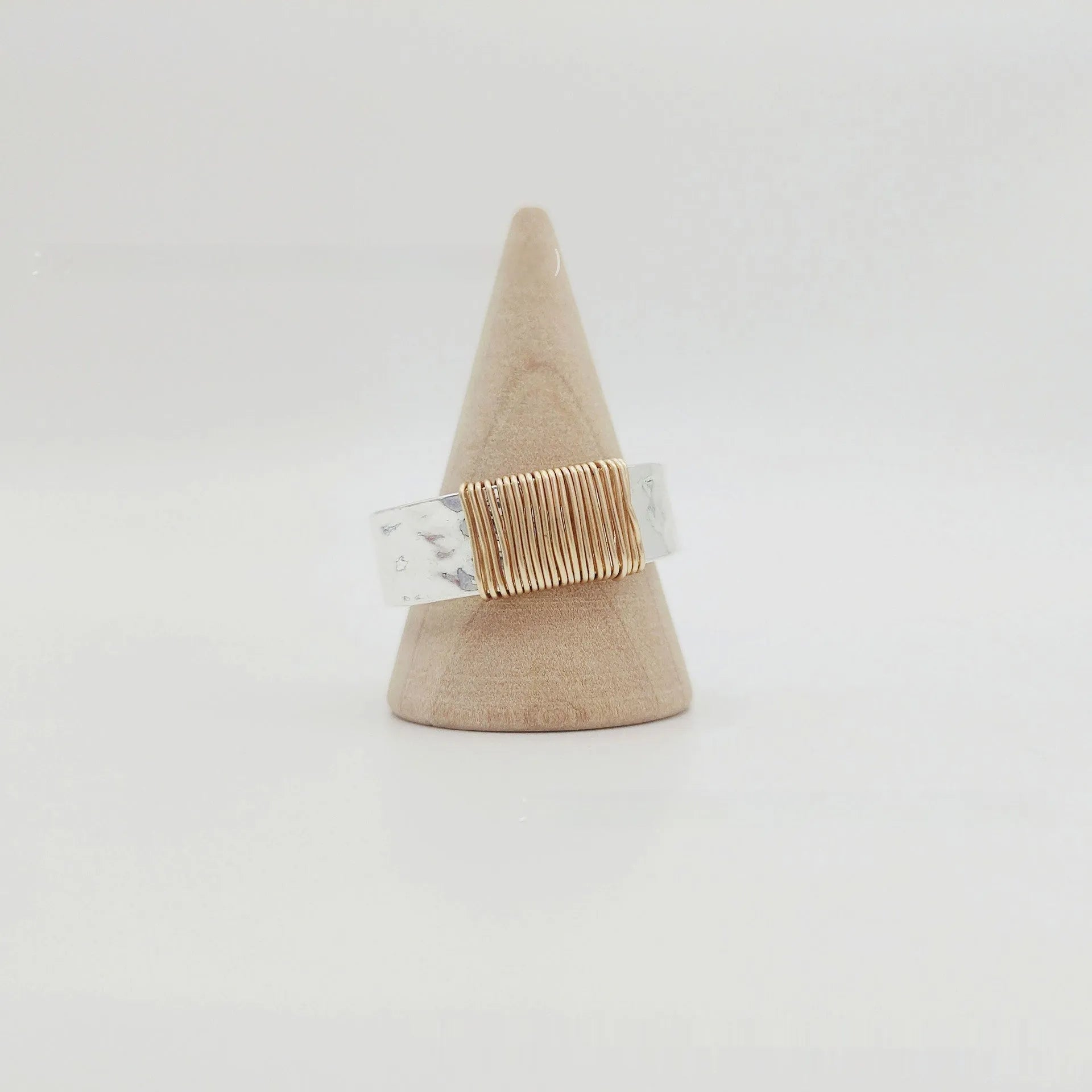 Geometric wide face copper bracelet ring with irregular coil design in silver gold finish.
