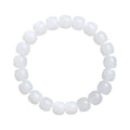 White Hetian jade barrel bead bracelet on a wrist, showing smooth beads in a unisex casual style.