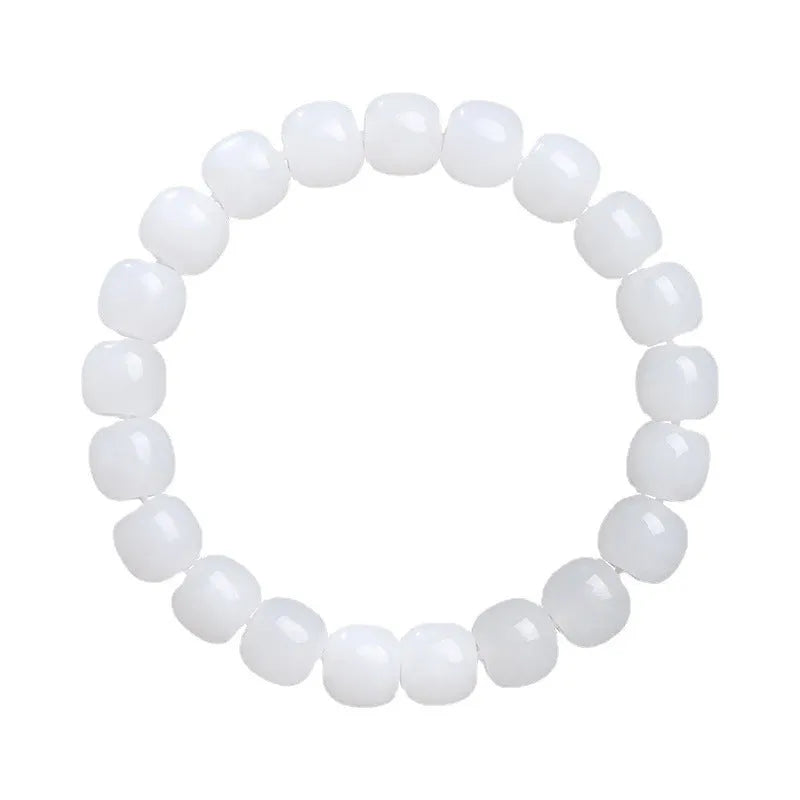 White Hetian jade barrel bead bracelet on a wrist, showing smooth beads in a unisex casual style.