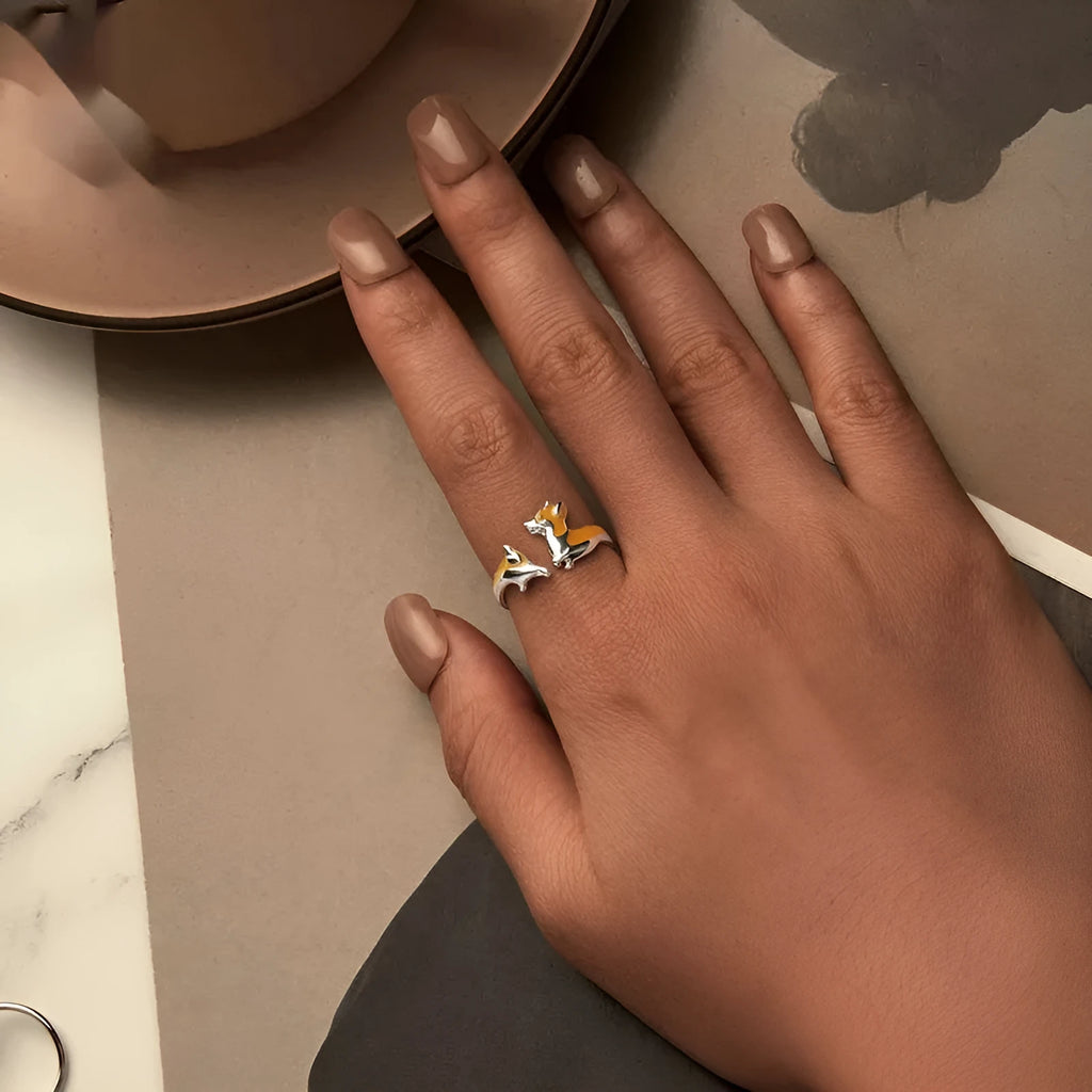 Silver corgi pet ring on a finger, showing cartoon animal design and adjustable band.