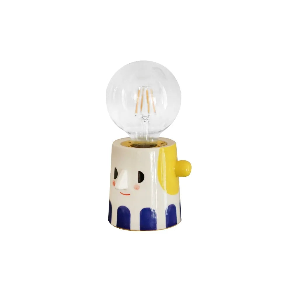 Handmade ceramic table lamp with a spherical ball headlight shape on a stand.