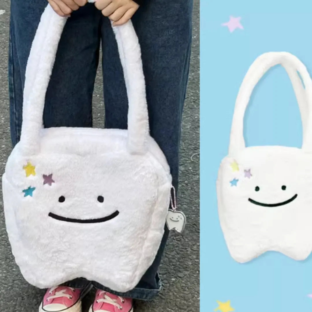 White large tote bag with plush large tooth shoulder strap and cute teeth design