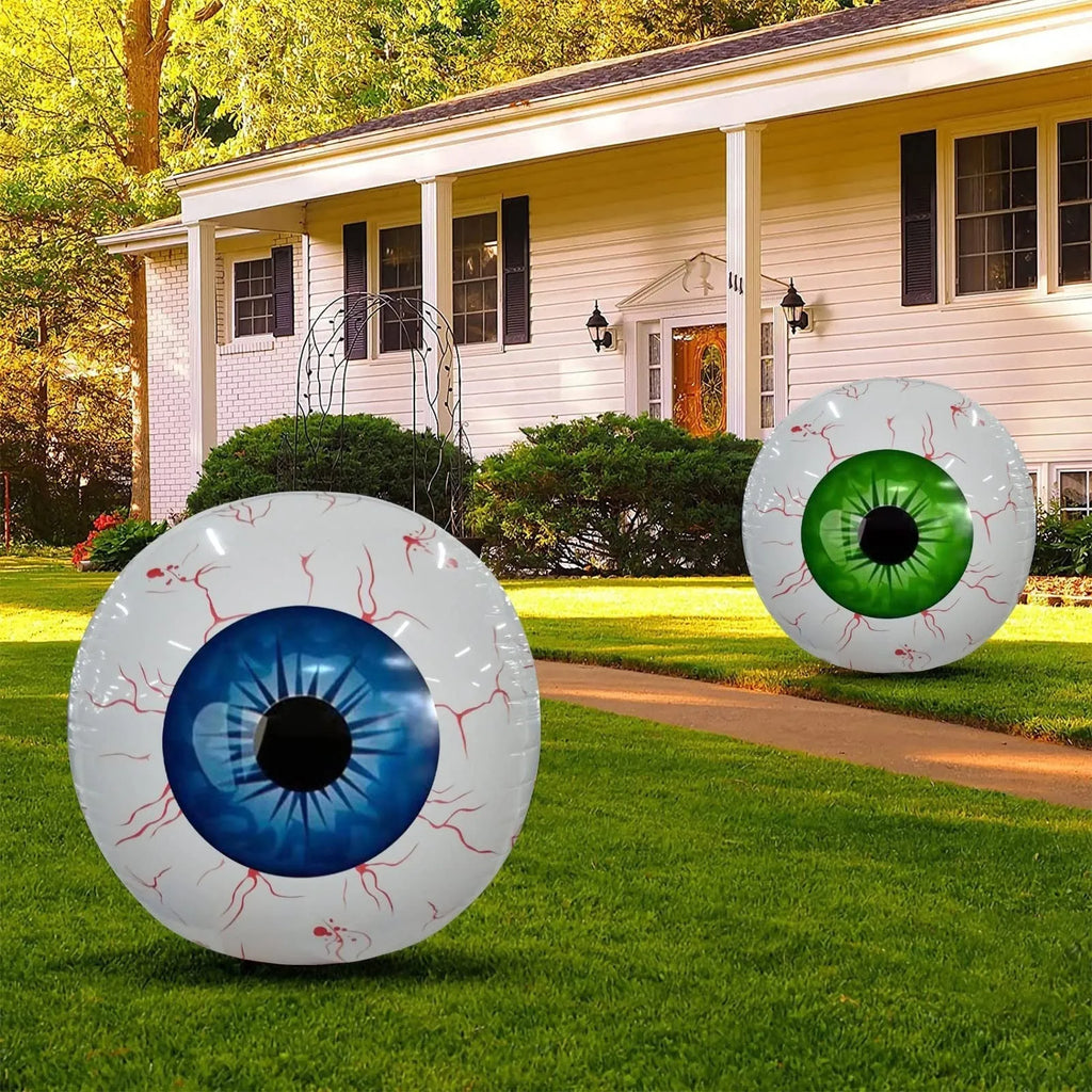 Large inflatable Halloween eyeball balloon with red bloodshot design on a white background