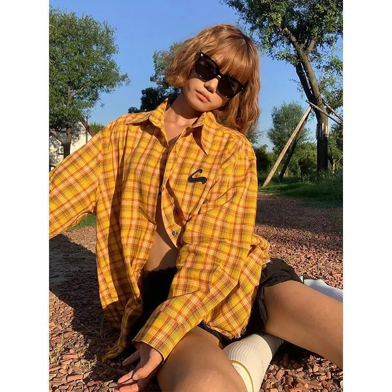 Dopamine yellow and black plaid shirt with a loose fit, shown on a hanger