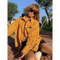 Dopamine yellow and black plaid shirt with a loose fit, shown on a hanger