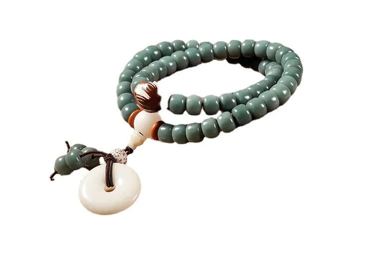 Bodhi seed beaded bracelet with a double ring safety buckle clasp featuring a Lotus detail.