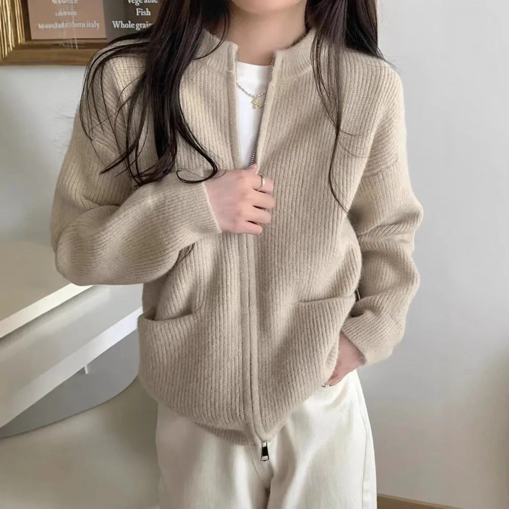 Beige soft viscose women's sweater coat cardigan with long sleeves on a hanger.