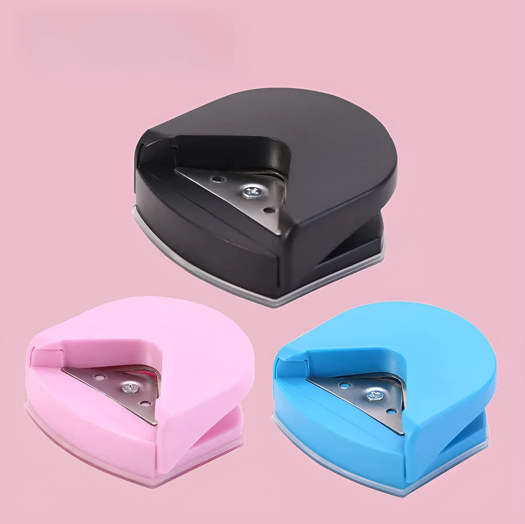 Corner cutter for paper cards and photos, plastic and metal, 5.8cm by 5.4cm by 2.5cm, in black, pink, or blue