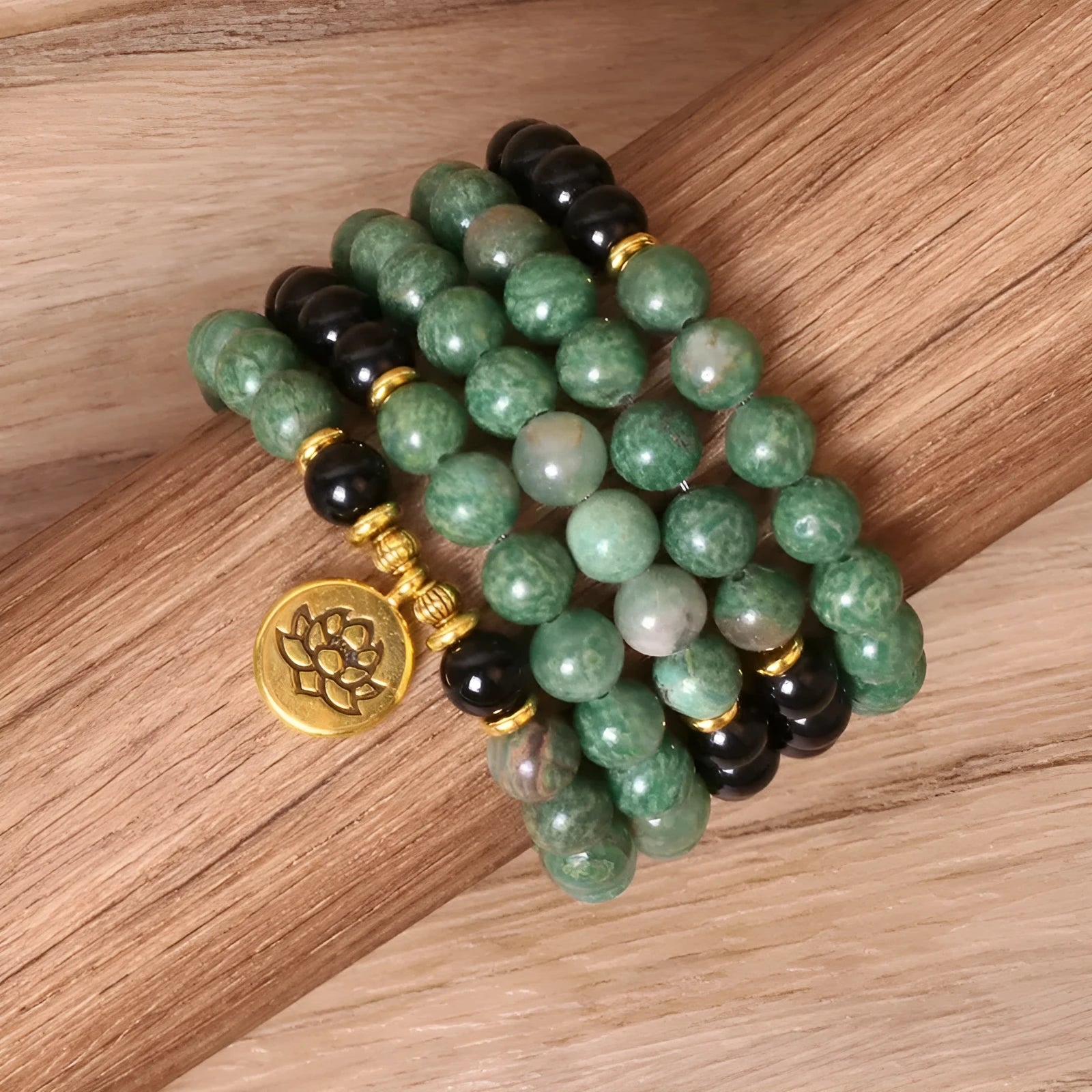 Green and black elastic beaded alloy bracelet on wrist showing natural style design