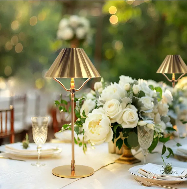 Gold alloy desk lamp with touch switch and interchangeable lampshade on a wooden desk