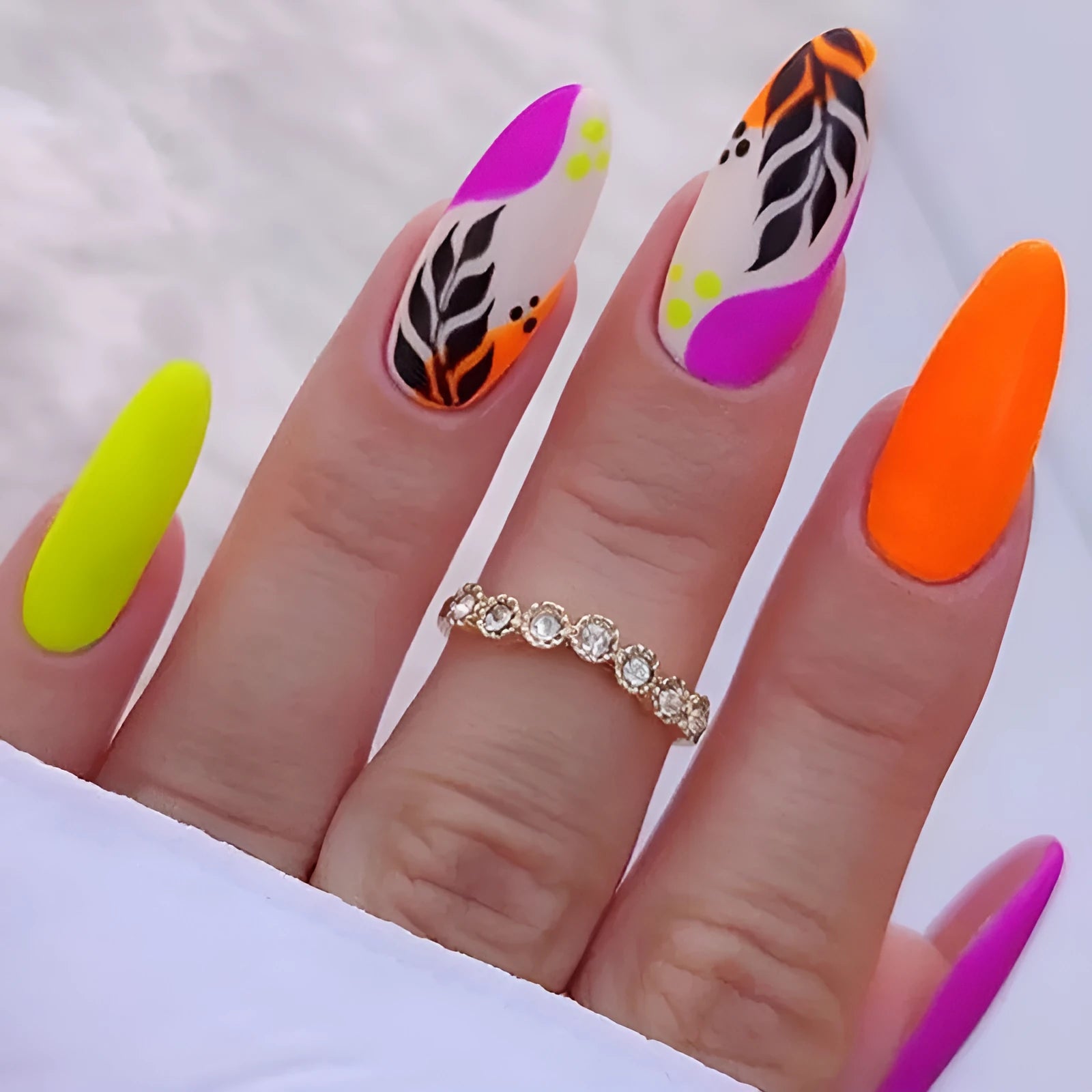 Wear Armour frosted nail stickers in medium almond shape showing tulip pattern in four colour designs.