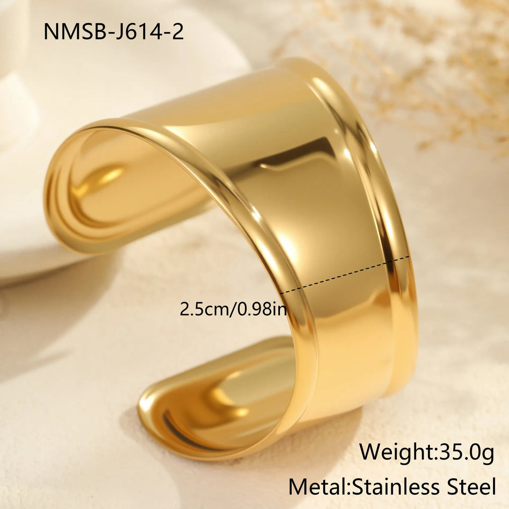 Women's fashion bracelet with exaggerated wide design and geometric wave pattern in gold plating