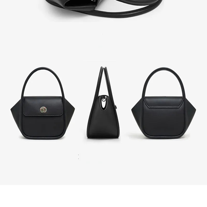Women's winged leather handbag with cross-body strap in blue, showing latch closure and buckle detail.