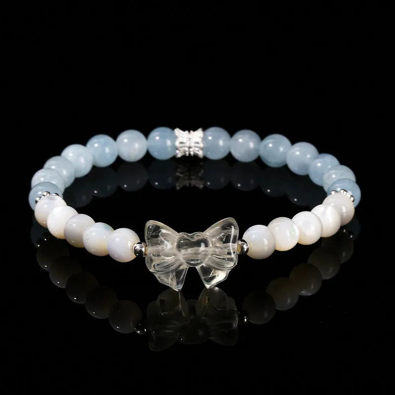 Women's natural starlight pink crystal cat head bracelet with copper detail and geometric round beads