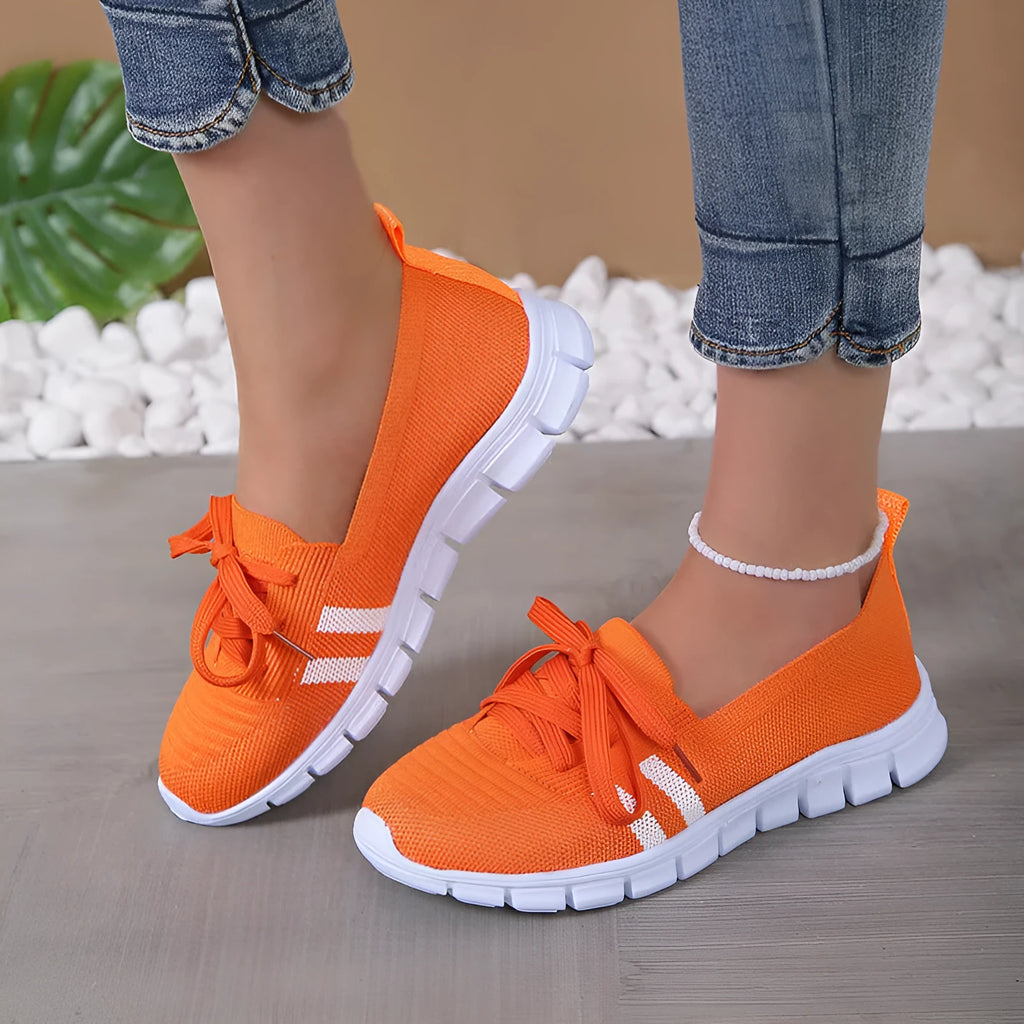 Women's lace-up mesh trainers with flat rubber sole, round toe and shallow mouth, shown in grey, black, orange and brown