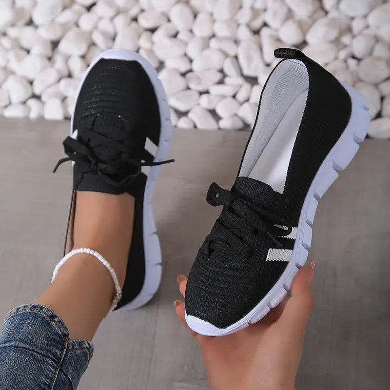 Women's lace-up mesh trainers with flat rubber sole, round toe and shallow mouth, shown in grey, black, orange and brown